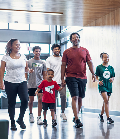 Young family walking into the rec center